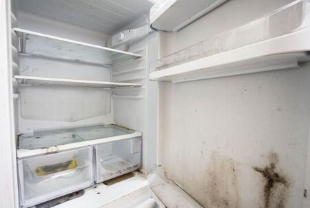 Old refrigerator with dirt and mold inside
